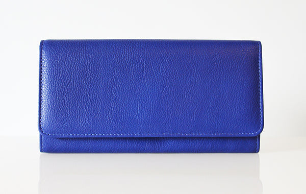 A bright blue Rogue Industries Campobello RFID Blocking Clutch closed and positioned horizontally on a white surface.
