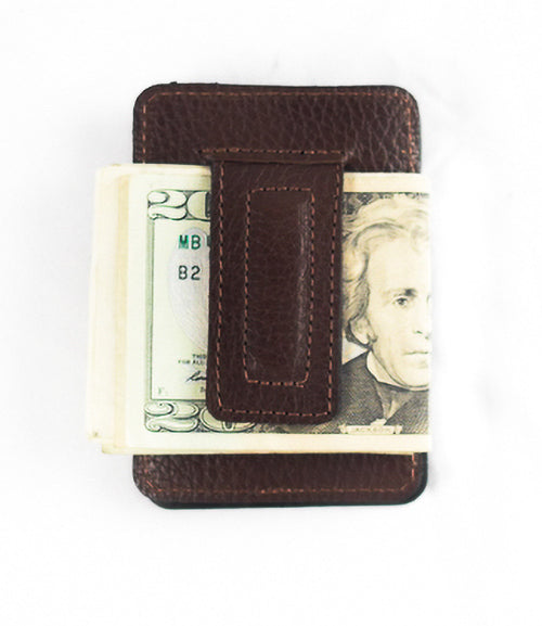 A front pocket Rogue Money Clip from Rogue Industries, crafted from genuine top-grain leather, designed to hold a stack of U.S. twenty-dollar bills.