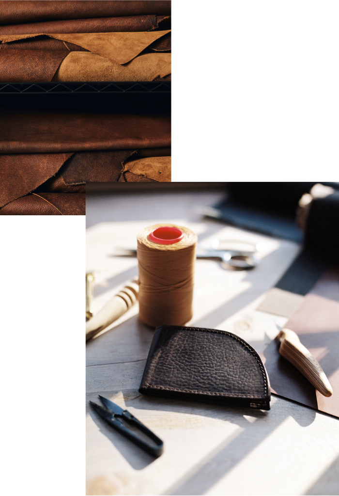 A leather wallet, scissors, and other items on a table.