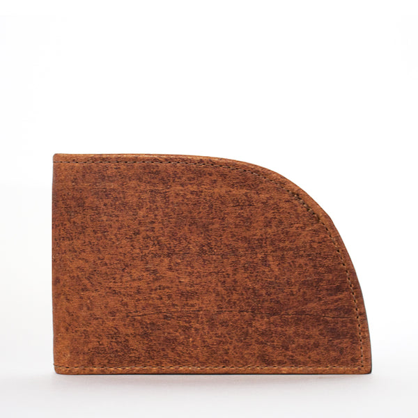 A wedge-shaped piece of Factory Second Made in Maine Front Pocket Wallet in BROWN, made by Rogue Industries, against a white background.