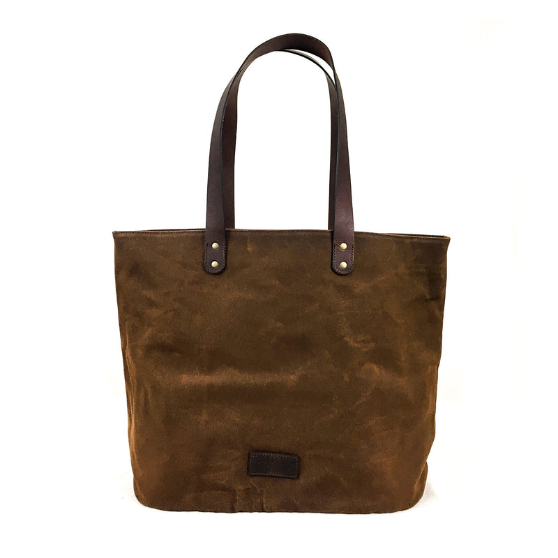 A durable Rogue Industries Waxed Canvas Tote Bag featuring dark top-grain leather straps and rivet details at the base of the handles.