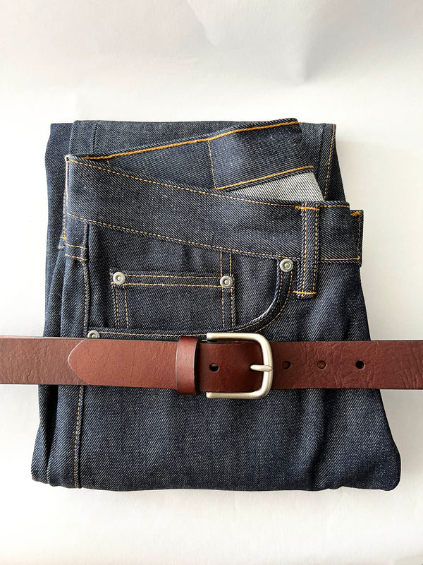 A pair of jeans with a Rogue Industries Chamberlain Leather Belt - 1.25" Wide.