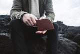 A person holding a Rogue Industries RFID-blocking Football Leather Front Pocket Wallet.